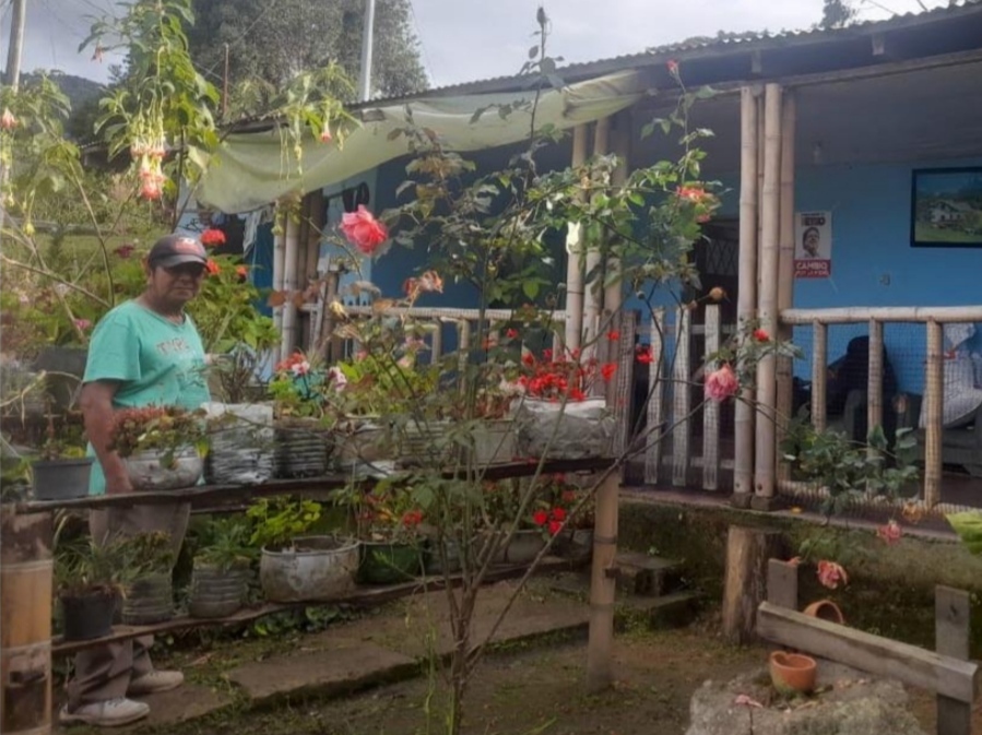 Javier Quintero's posing before his house.