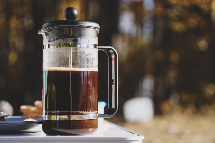 Image of someone making French press (plunger)