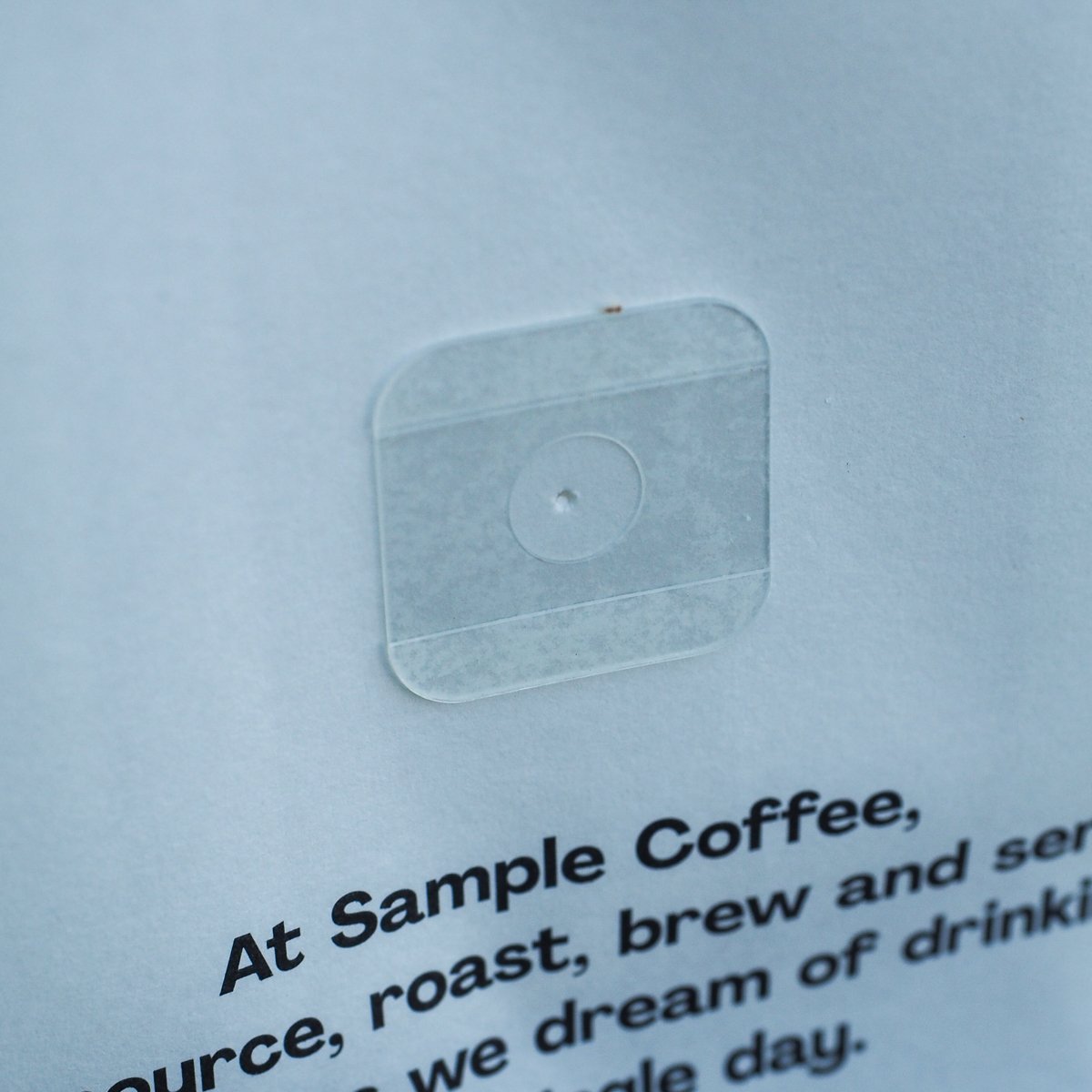 A close view of a degassing valve in the rear of a coffee bag.