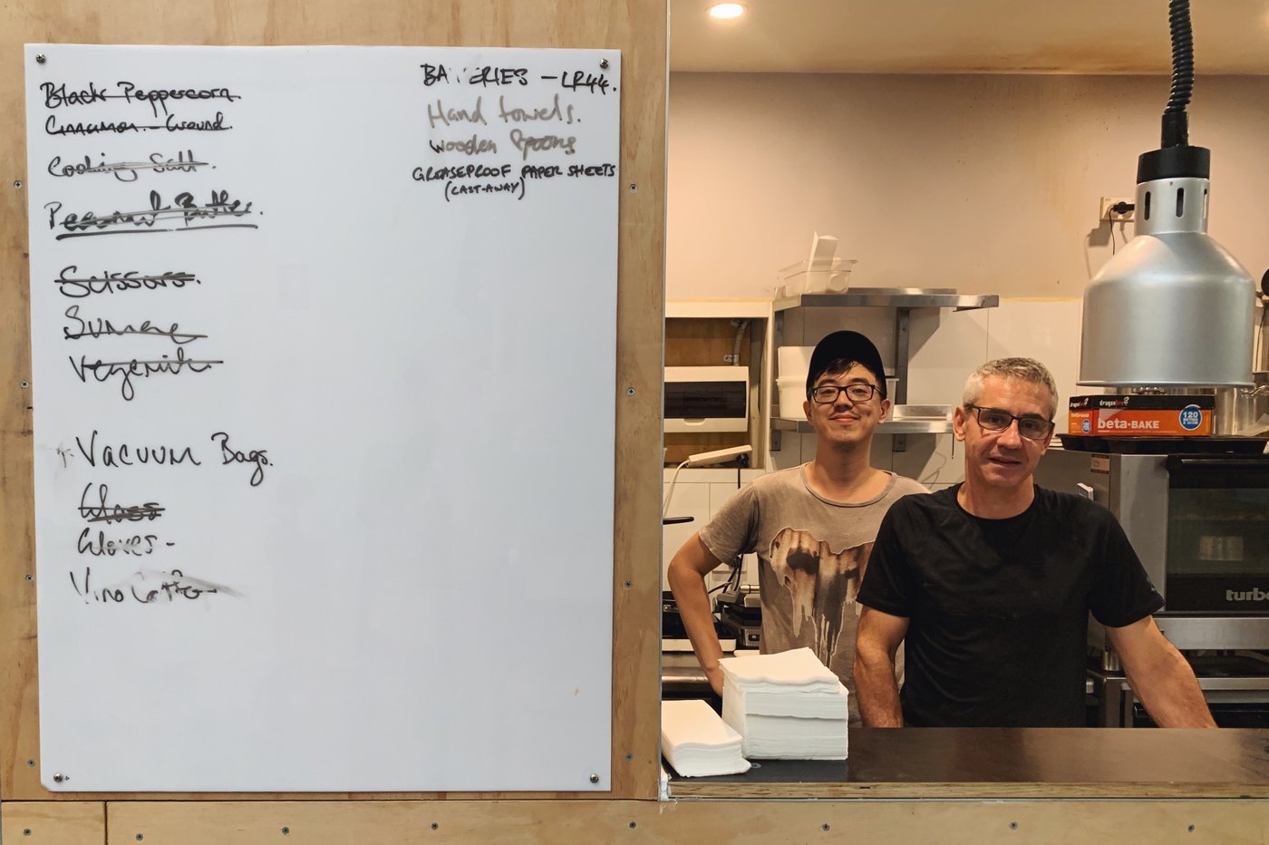 A chef at Sample's kitchen with the updates board