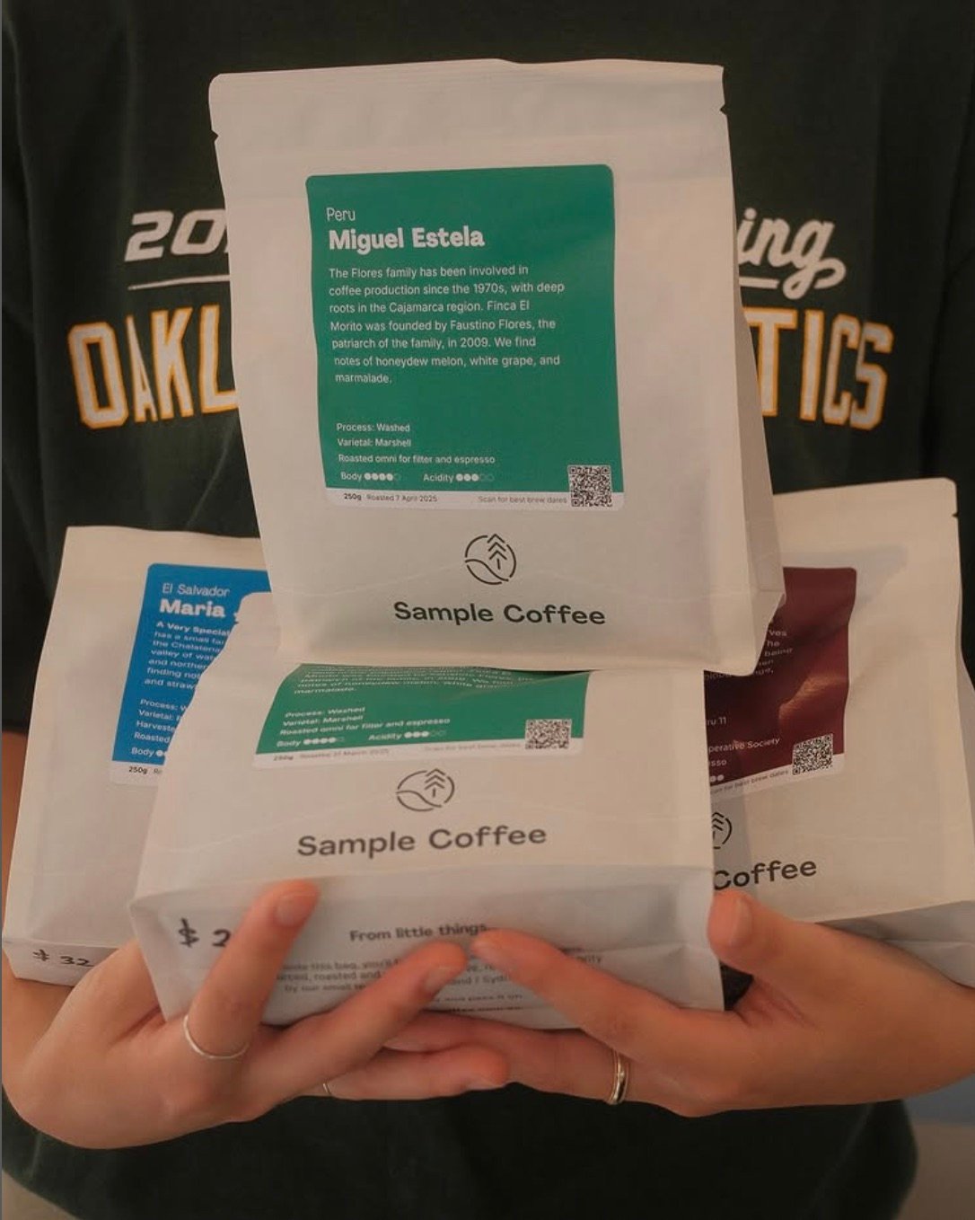 Sample Coffee bean bags held by a staff at Kurumac.
