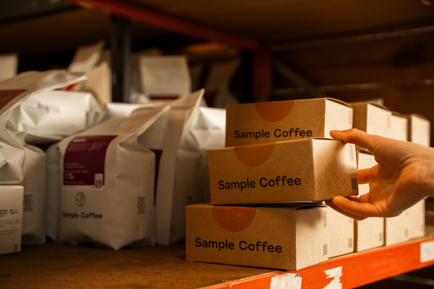 Someone grabbing a Sample Coffee subscription box in our roastery.