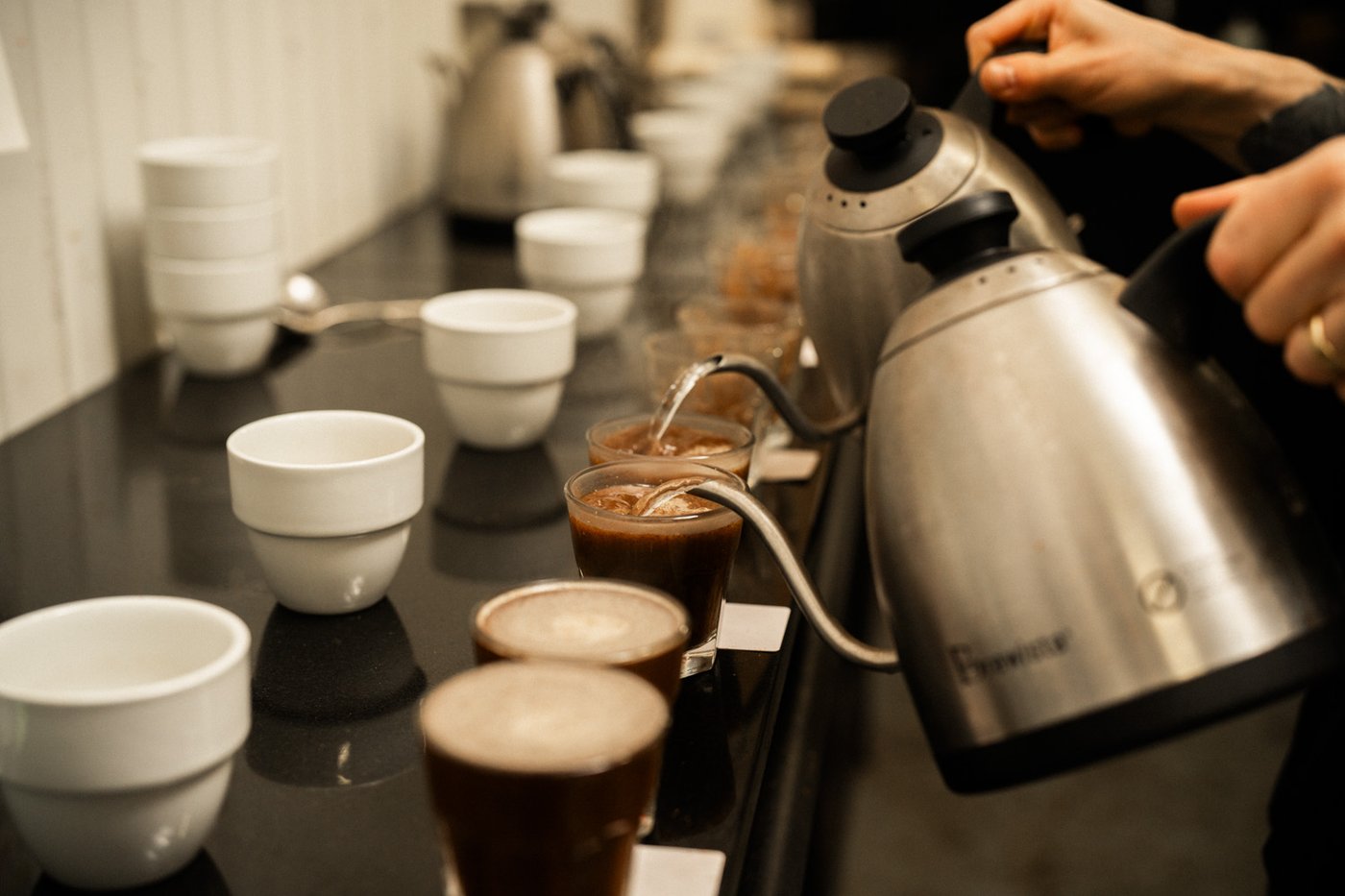 Quality control cupping detail of cups at Sample Coffee roastery.