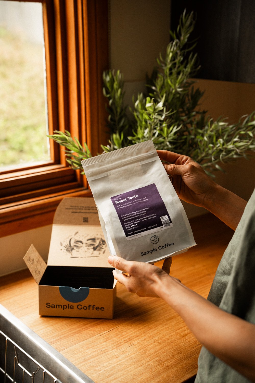 A bag of Sample Coffee beans and the delivery box.