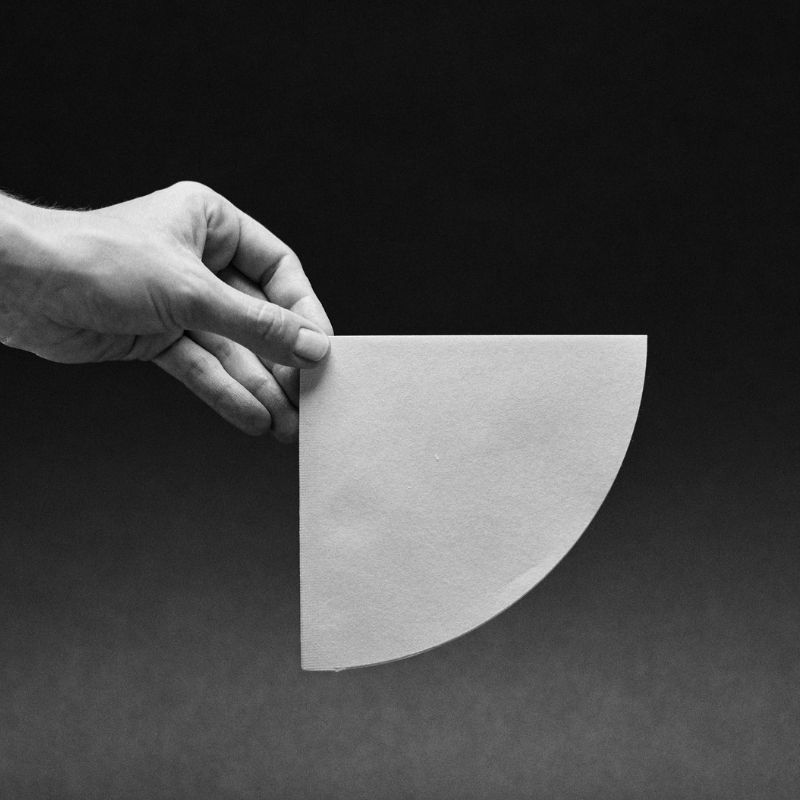 A hand holding a Sibarist cone filter.